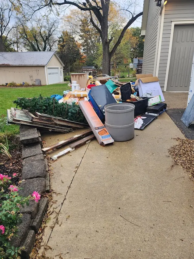 Dumpster being loaded with debris for Estate Cleanout Dumpster Rental in Lauderdale-by-the-Sea